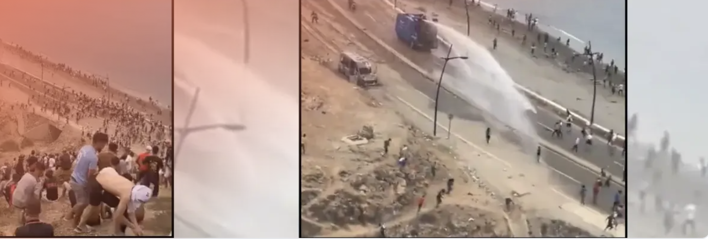 Fotograma del vídeo de personas migrantes en la playa junto a un camión antidisturbios